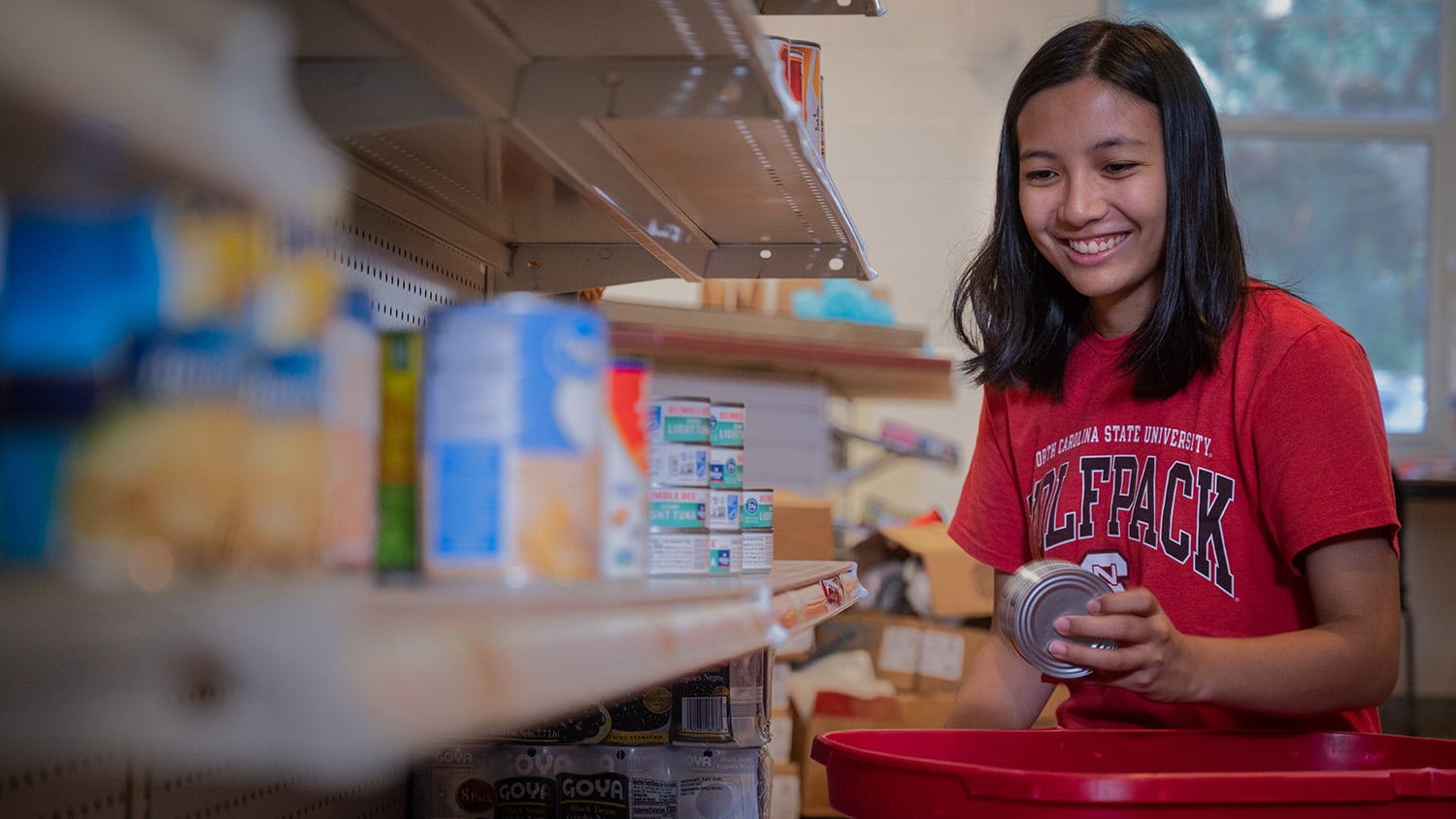 A student volunteer works at Feed the Pack, NC State's on-campus food pantry.