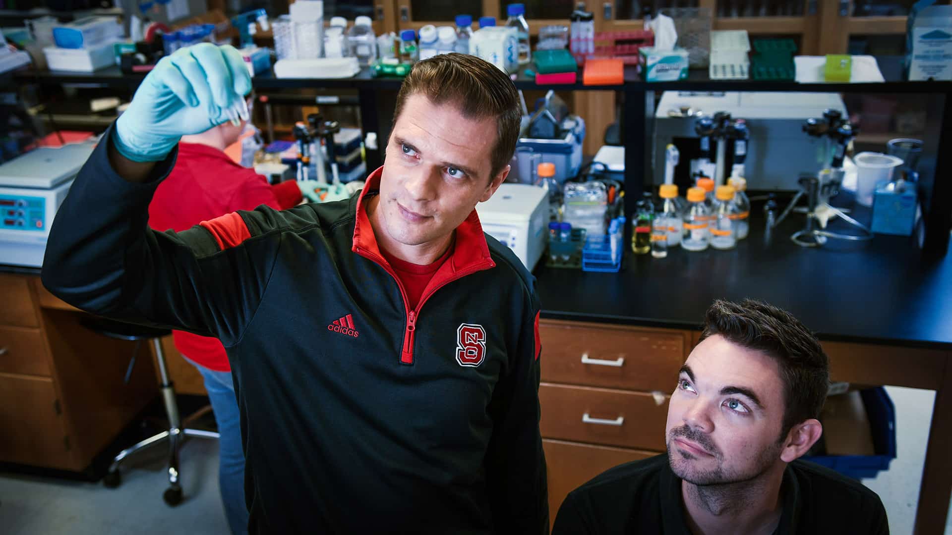 Rodolphe Barrangou, the Todd R. Klaenhammer Distinguished Scholar in Probiotics Research and the lead coordinator for the new biomanufacturing-focused faculty cluster, gazes at a sample alongside another researcher in his lab.