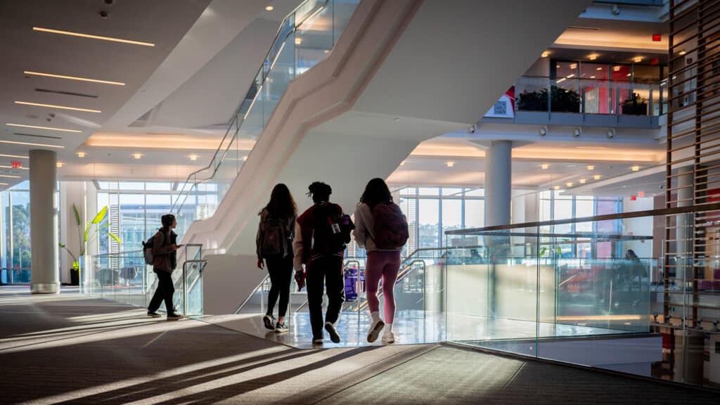 Late afternoon light streams through the Talley Student Union windows, creating long shadows as students move through the space.