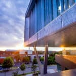 The sunset reflects on the windows of Fitts-Woolard Hall.