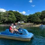 Two students use a paddle boat at Pullen Park's pond.