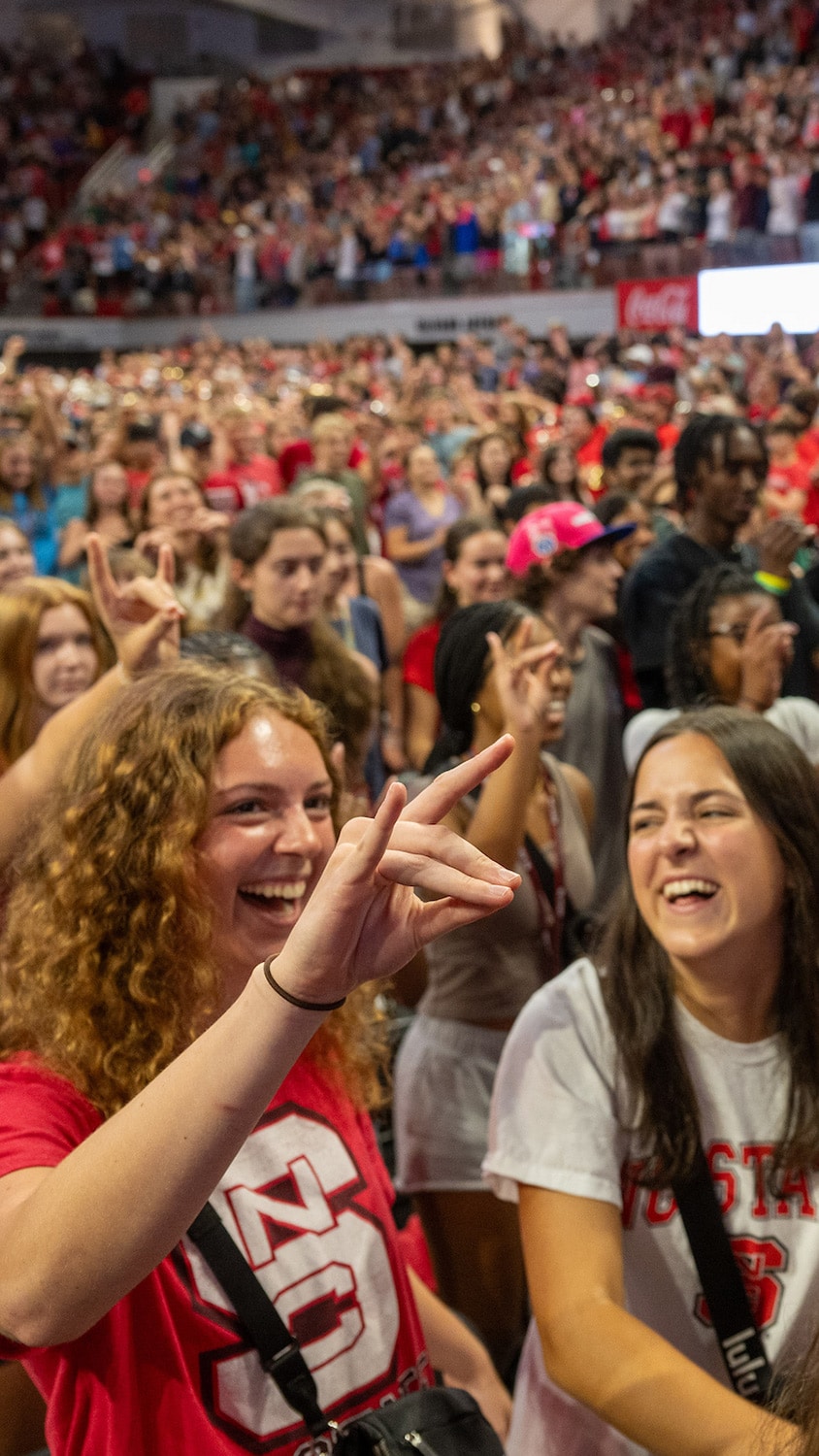 Students cheer during Convocation at Reynolds Coliseum.