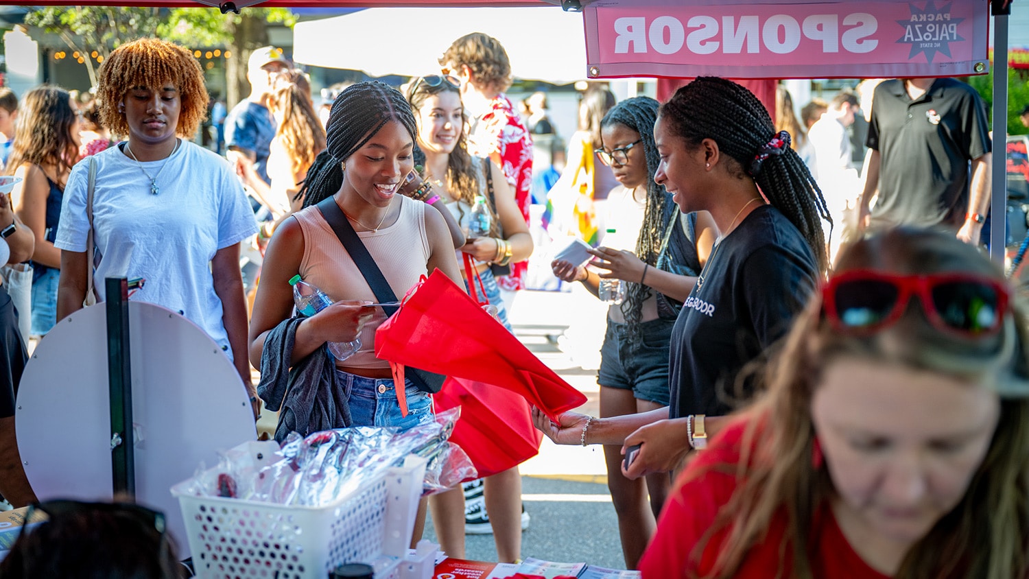 A student stops by a street vendor during Packapalooza, NC&#160;State's all-day street festival kicking of each new school year.