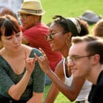 Two students hold up wolfies during a Wolfpack Welcome Week event.