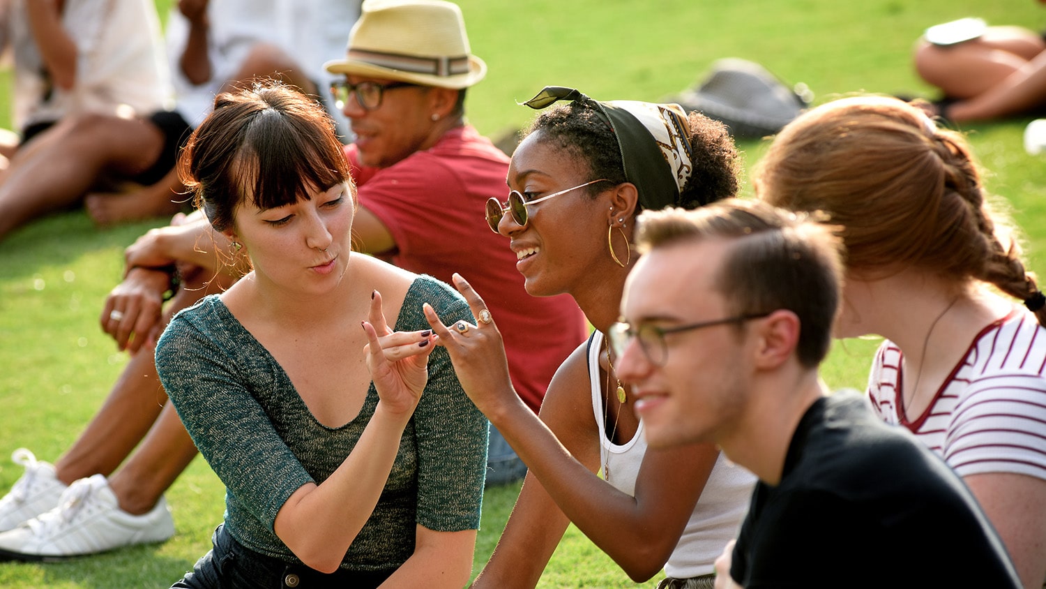 Two students hold up wolfies during a Wolfpack Welcome Week event.