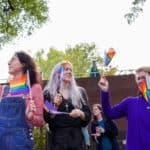 NC State students, staff, faculty and friends of the Wolfpack wave rainbow Pride flags during the 2022 Pride Walk.