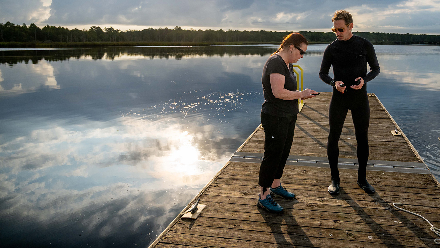 Astrid Schnetzer and Tal Ben-Horin stand on a dock in Aurora, North Carolina.