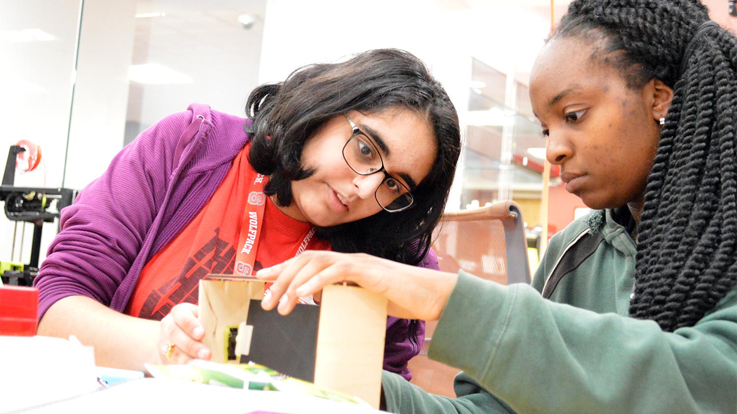 Two students build a solution to a sustainability challenge during Make-A-Thon.