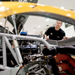 Engineers Luke Lambert ’05 works on a race car.