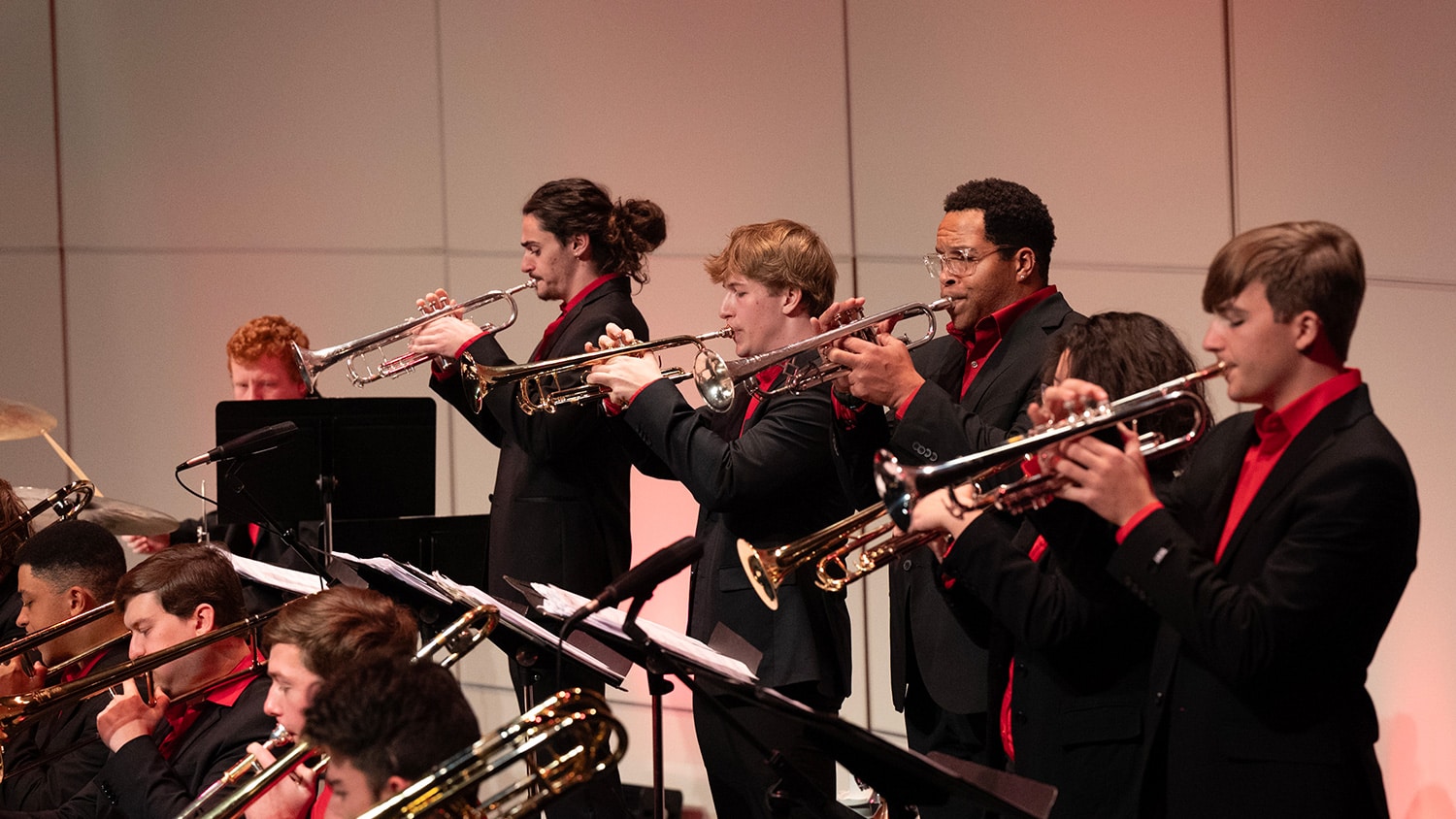 Five students play the trumpet during a jazz orchestra concert in Stewart Theatre.